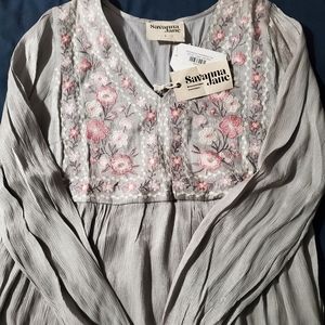 Flowing, shimmering embroidered top